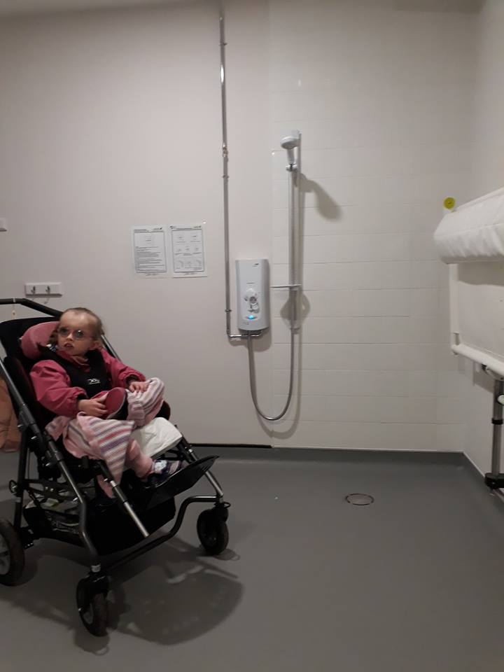 Picture of a Changing Space toilet, with a child in a pram to help scale