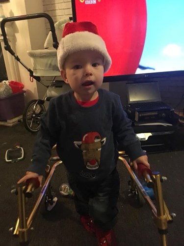 Picture of a young child with a festive hat and a walker